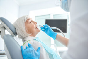 senior woman preparing to receive dental procedure after asking what are 3 things you should know about general dentistry treatments